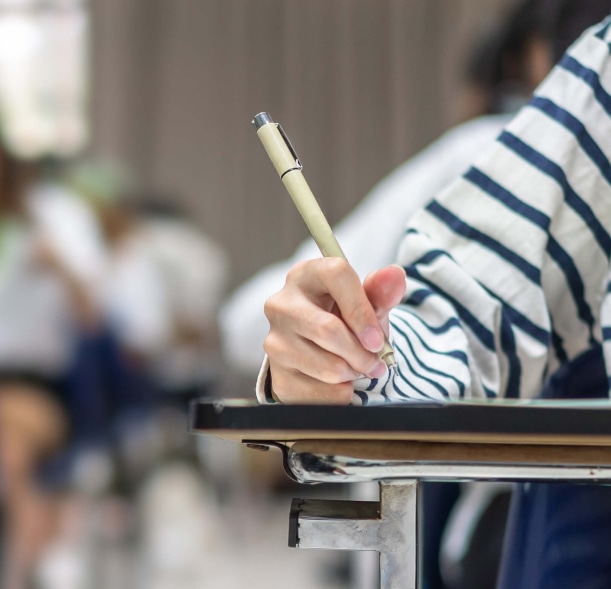 a person holding a pen in their hand