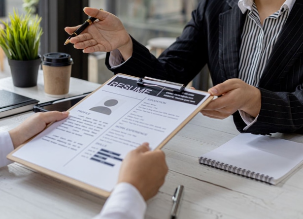 a person holding a clipboard with a pen